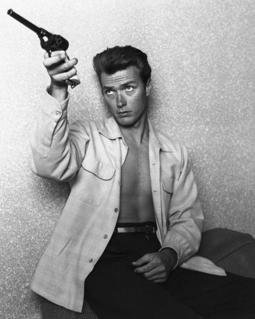Clint Eastwood checks his gun at home on June 1, 1956 in Los Angeles, California.