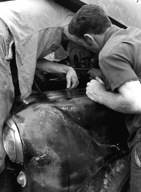 men together fixing car 1281