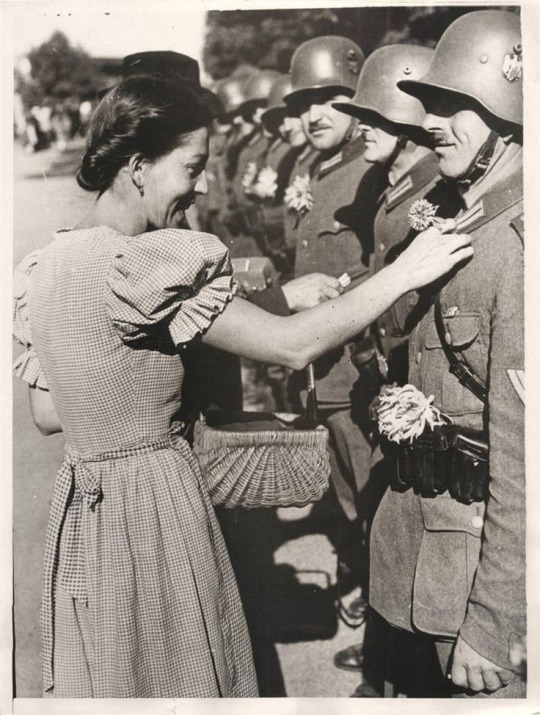 a-local-girl-pinning-a-flower-on-a-german-soldiers-uniform-in-olbersdorf-as-nazi-forces-occupy-the-sudetenland-1938