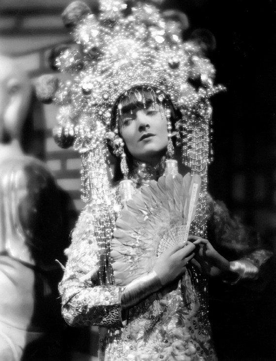 circa 1935: American actress Myrna Loy wearing an elaborate Balinese costume in a scene from an unknown film.