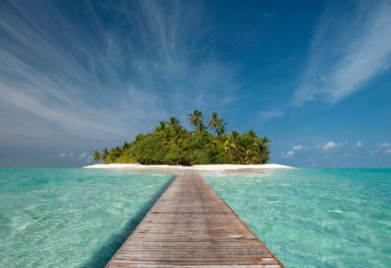 Wooden dock walkway to tropical island