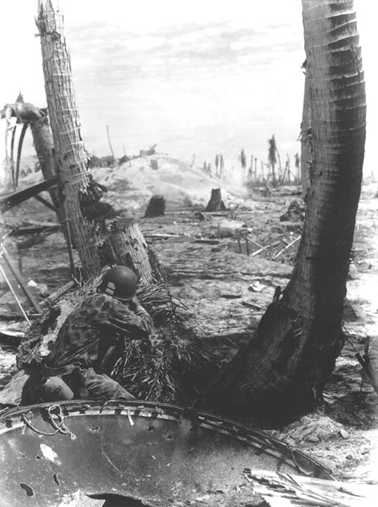US Marine holding a position in the completely destroyed Gilbert ...