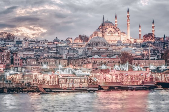 Suleymaniye Mosque shot at blue hour with colorful boats, Istanbul, Turkey.