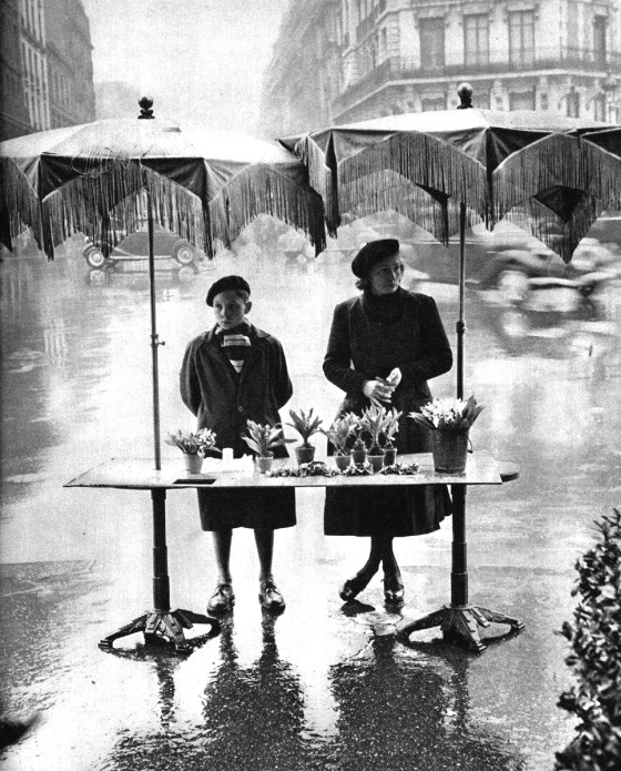 Selling flowers in the rain, Place Victor-Basch, Paris, circa 1950. Photograph by Izis Bidermanas.
